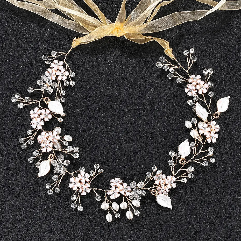 A delicate rose gold-toned pearl handmade headband featuring alloy flower design with pink crystal flowers, clear rhinestones, and white pearl-like leaves.