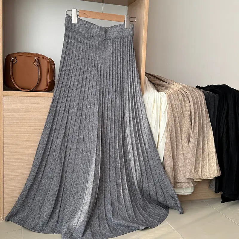 a long gray knit midi skirt with a pleated ribbed texture and subtle sheen featuring a korean elastic waist for comfortable fit
