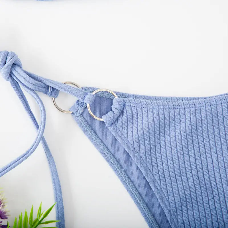 Light blue ribbed fabric bikini bottom with adjustable tie thong bandage straps and silver metal rings from the white ribbed sexy bikini set with gold ring accents.