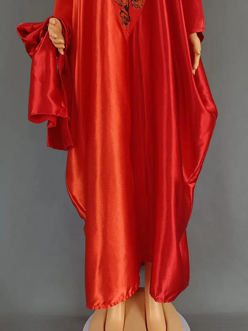Vibrant red satin robe with flowing wide sleeves and decorative embroidered neckline in ethnic style.