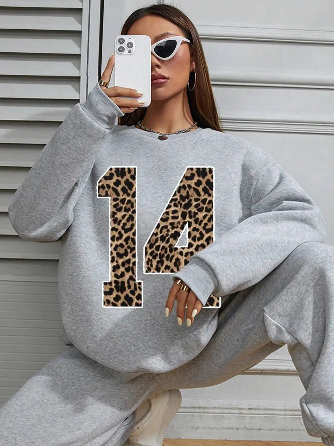 gray crew neck sweatshirt featuring a leopard print number 14 on the front designed as a casual neck sweatshirt