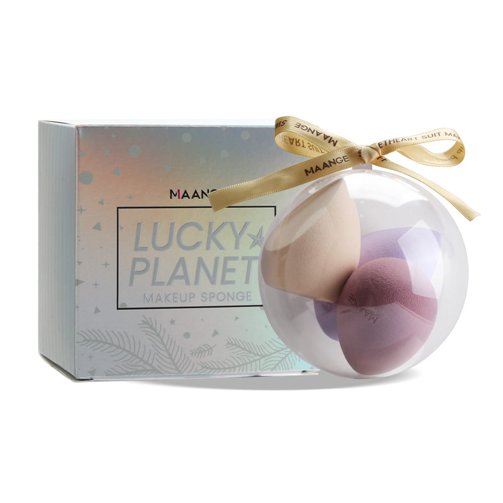 Clear spherical container holding three multicolored spherical beauty egg makeup sponges in beige lavender and purple hues for makeup application.