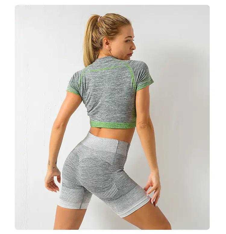 Gray and green heathered women’s seamless yoga two-piece workout set with ribbed detailing and hip lifting design.