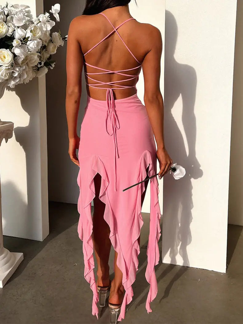 a pink sexy suspender tight two-piece outfit with a strappy crisscrossed back top and a high-slit tight slim skirt featuring layered ruffles shown from the back side