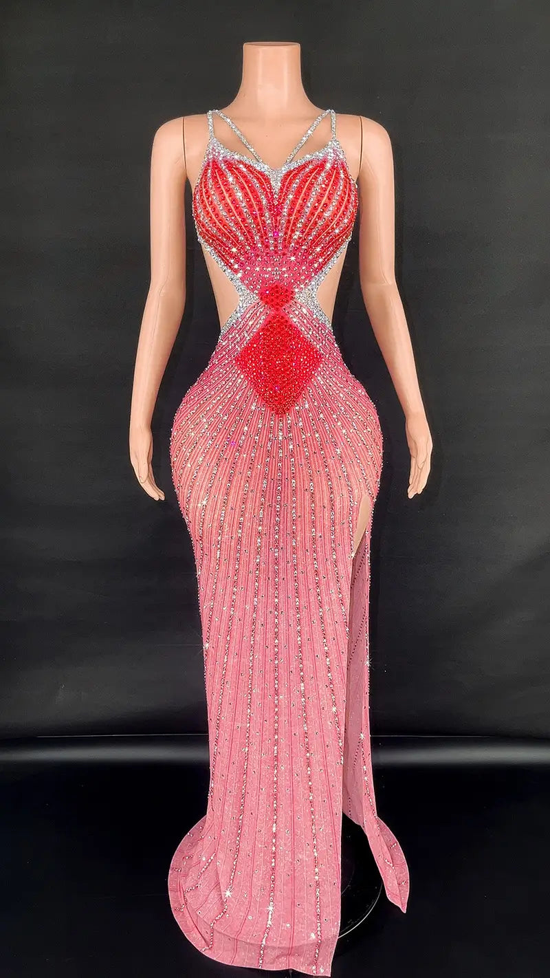 a shimmering pink and red beaded mermaid-style sling super shiny evening gown featuring a heart-shaped bodice, silver embellishments along the straps and seams, and a high slit on the side