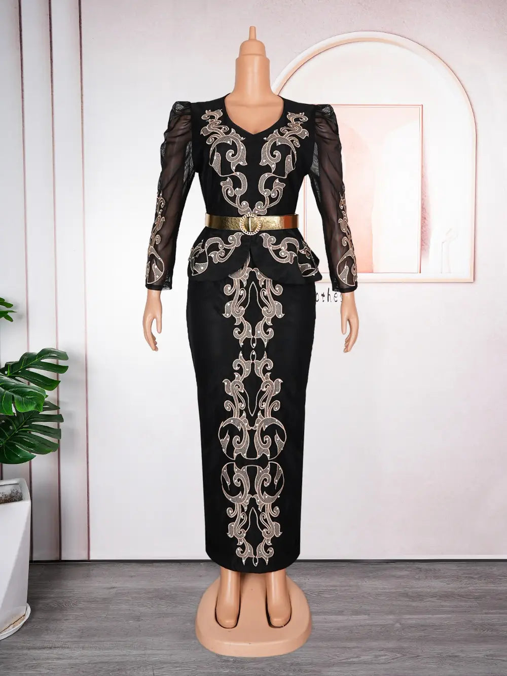Luxury rhinestone beaded black peplum formal dress with intricate silver embroidery, sheer long sleeves, and a gold belt accent.