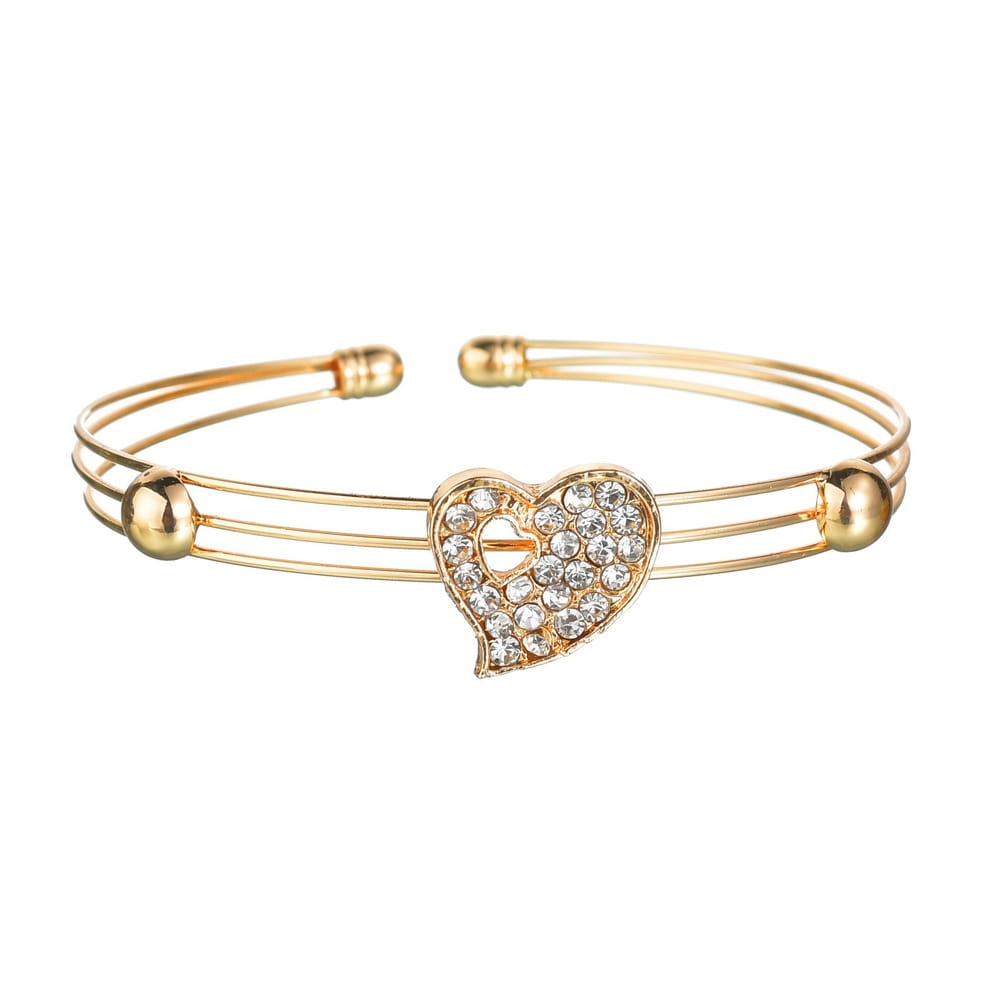 Gold-toned bangle from a love jewelry set featuring a heart-shaped centerpiece adorned with clear crystals and spherical accents.