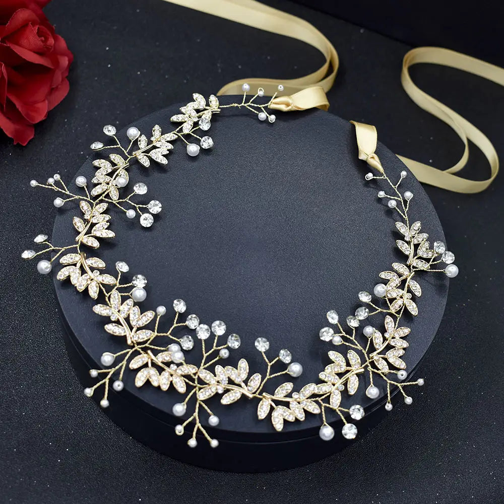 Elegant gold-toned bridal hair band rhinestone with silver leaf design adorned with sparkling crystals and delicate pearls in band rhinestone alloy.