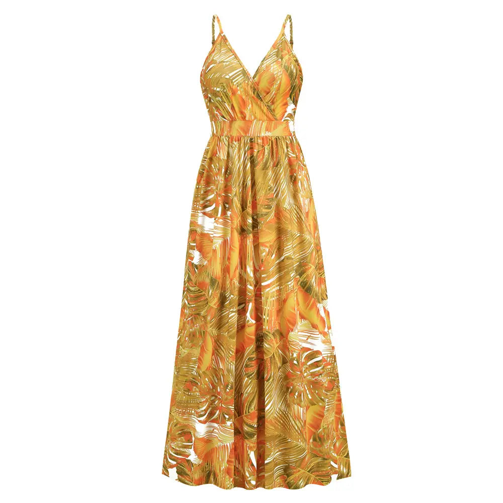 A flowing long dress summer swing with long sleeves and thin spaghetti straps in vibrant orange and gold tropical leaf print.