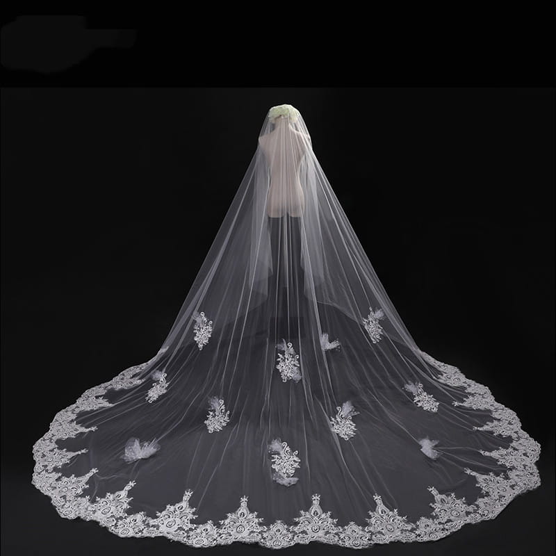 a delicate white lace wedding veil with intricate floral embroidery and scalloped edge displayed on a mannequin showcasing the long lace wedding veil meters wide style