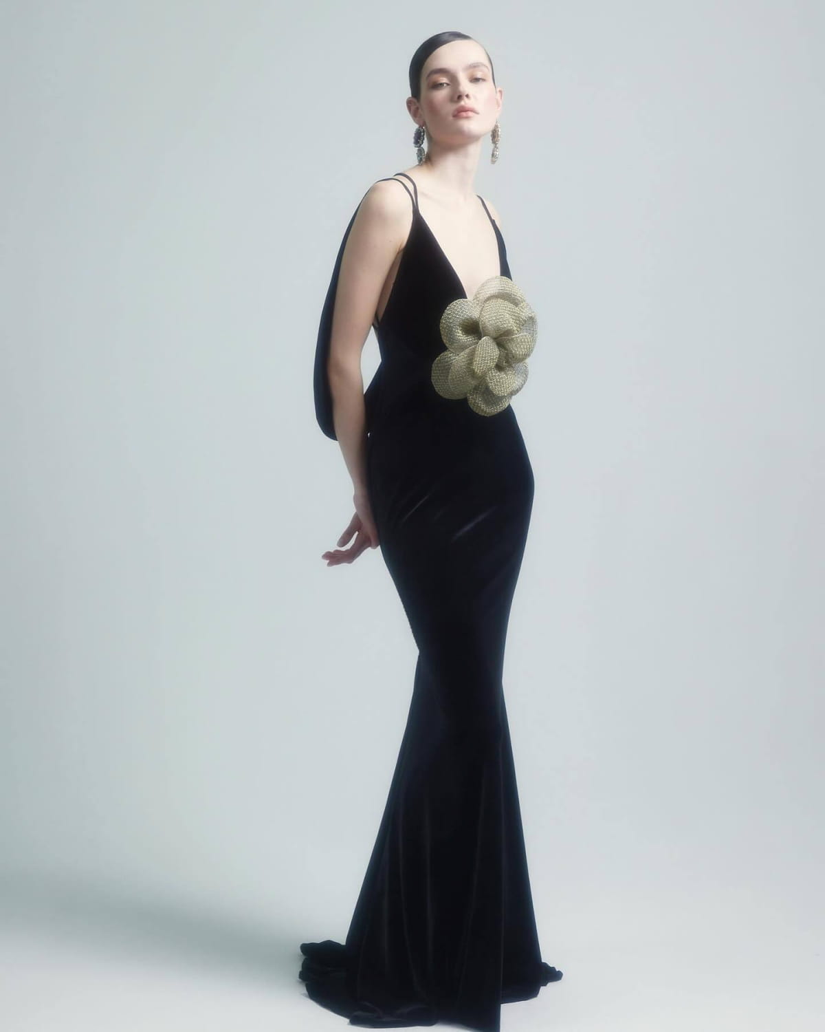 Black camisole backless slim fit velvet gown featuring a black velvet mermaid silhouette with textured olive-green floral embellishment on the bodice.