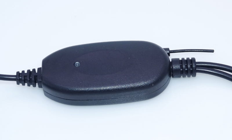 black plastic power adapter with a smooth oval-shaped body and three bundled cables extending from one end for a 7 inch wireless suction cup display hd rearview camera