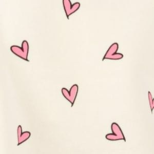 a soft cream-colored fig heart printed long sleeve sweatshirt featuring scattered pink hearts outlined in black with heart printed contrast details