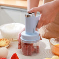 Light blue and silver handheld meat grinder with transparent container in electric hand whisk set with speed settings
