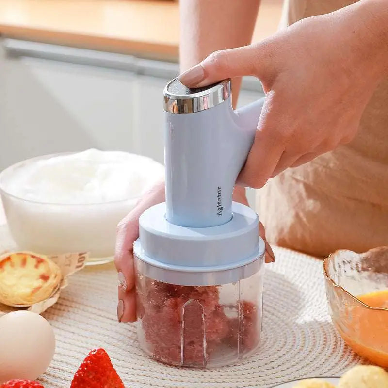 Light blue and silver handheld meat grinder with transparent container in electric hand whisk set with speed settings