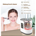 White and rose gold electric makeup brush cleaner with transparent design and multiple brush slots in cylindrical tank