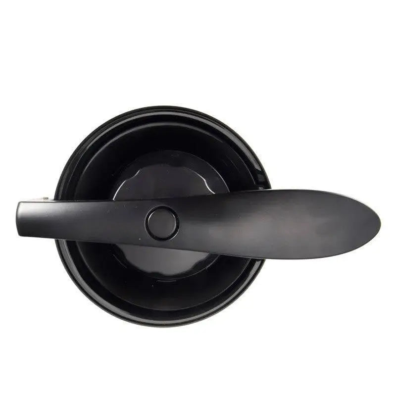 Black and stainless steel electric orange juice separation machine with handle squeezing orange into glass juice