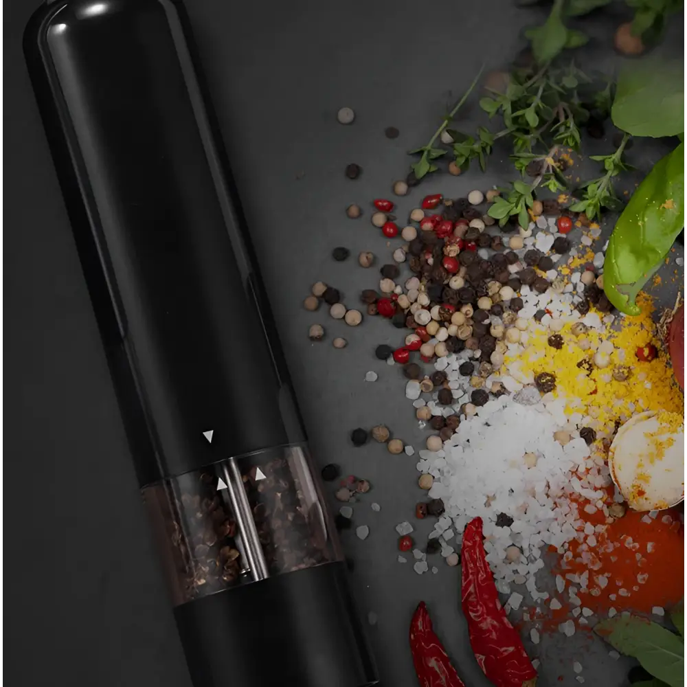 Black electric pepper mill with clear glass chamber filled with peppercorns from electric salt–pepper grinder set