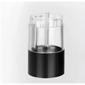 Transparent acrylic pencil sharpener with black base and metallic components displayed alongside electric salt pepper grinder set