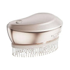A sleek rose gold electric spray massage comb with curved design and white bristles for hair care spray use