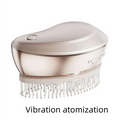 A rose gold electric spray massage comb with white bristles designed for effective hair care spray and scalp massage