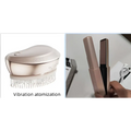 Rose gold electric spray massage comb with bristles and sleek rounded design for hair care spray use