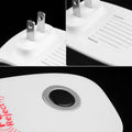 White plastic electronic ultrasonic healthy pest repeller plug with silver prongs and a circular black reject button