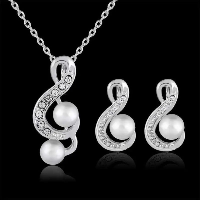 Elegant bride wedding silver musical note pendant necklace with crystals and pearls paired with matching pearl two piece earrings
