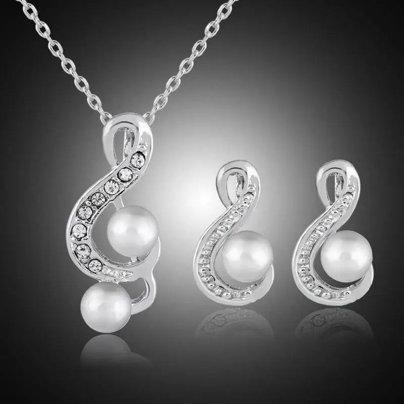 Elegant bride wedding silver musical note pendant necklace with crystals and pearls paired with matching pearl two piece earrings