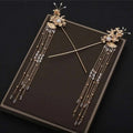 Elegant chinese bridal jewelry featuring gold-colored ornate hairpins with intricate floral designs pearls and crystals