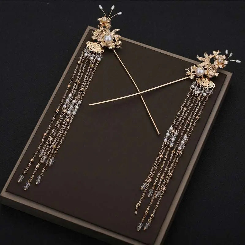 Elegant chinese bridal jewelry featuring gold-colored ornate hairpins with intricate floral designs pearls and crystals