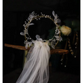 Elegant floral bridal wreath veil in ivory lace adorned with silver leaves and beads featuring a flowing tulle veil