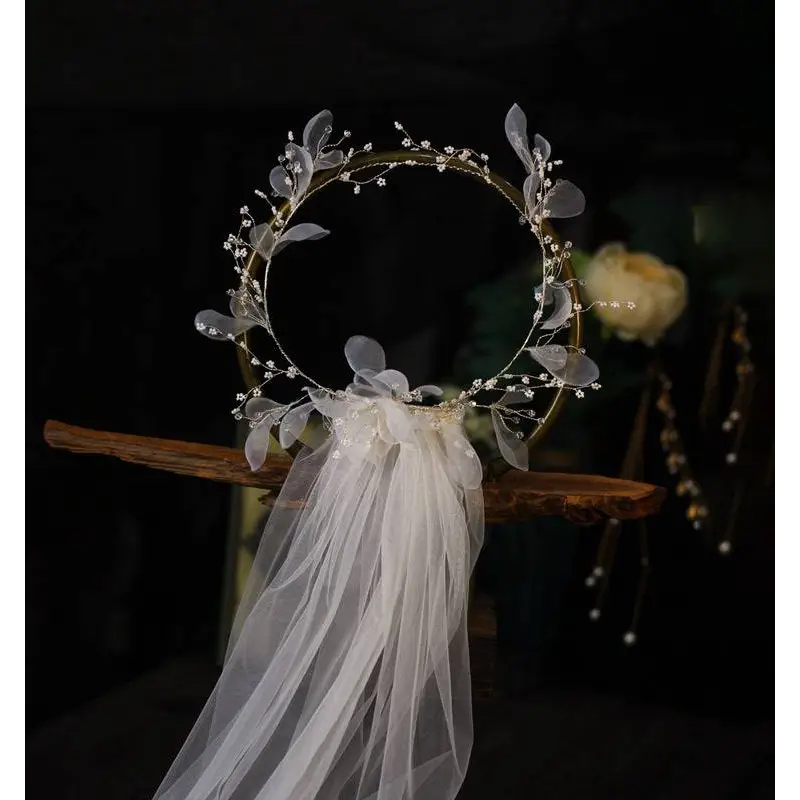 Elegant floral bridal wreath veil in ivory lace adorned with silver leaves and beads featuring a flowing tulle veil