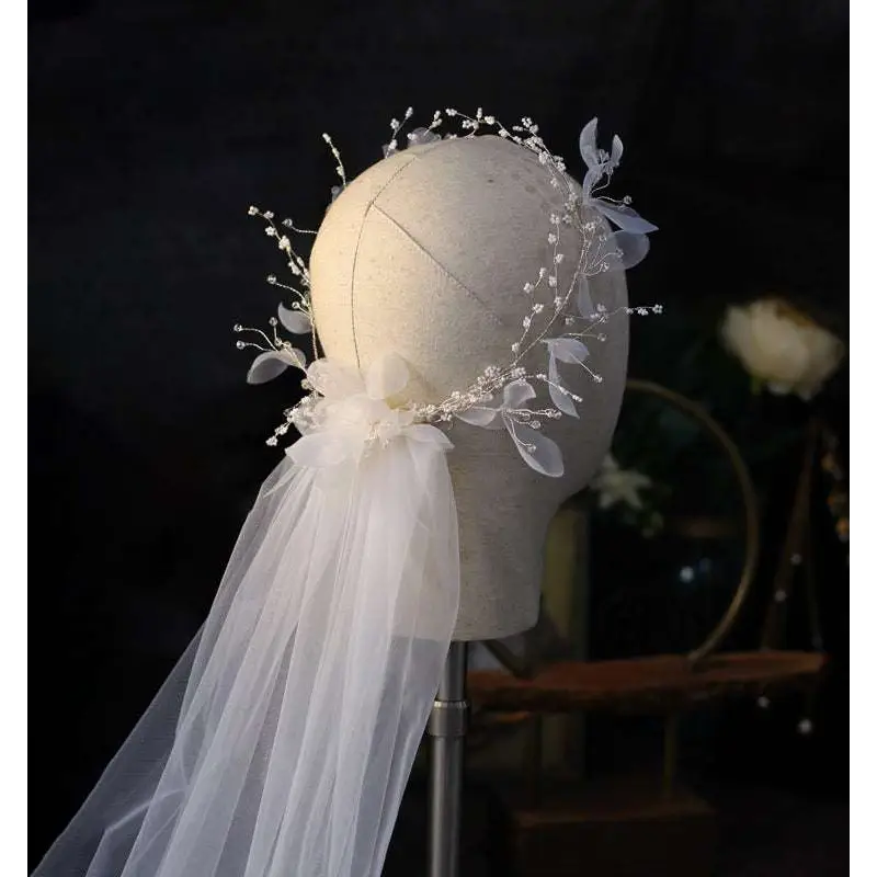 Elegant white floral bridal wreath veil adorned with sheer tulle and sparkling beaded vines for weddings