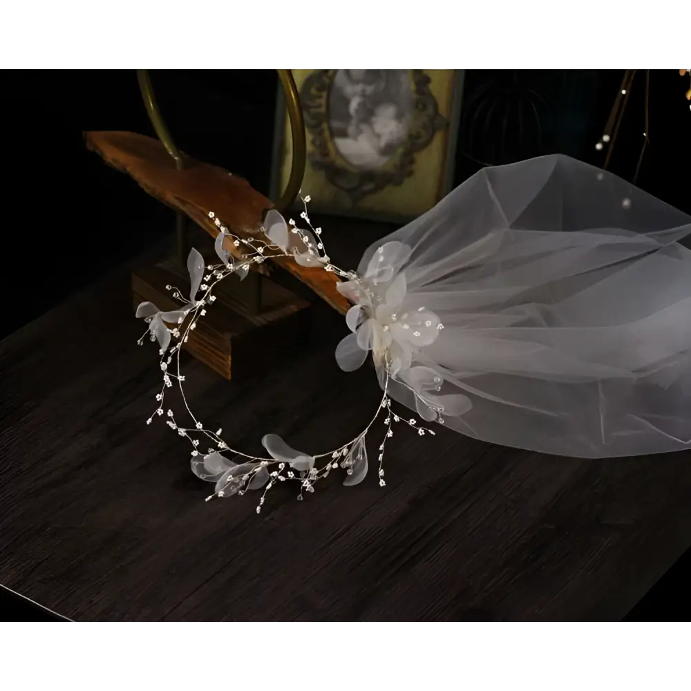 Elegant floral bridal wreath veil in silver tone adorned with sheer white organza flowers and sparkling crystal beads