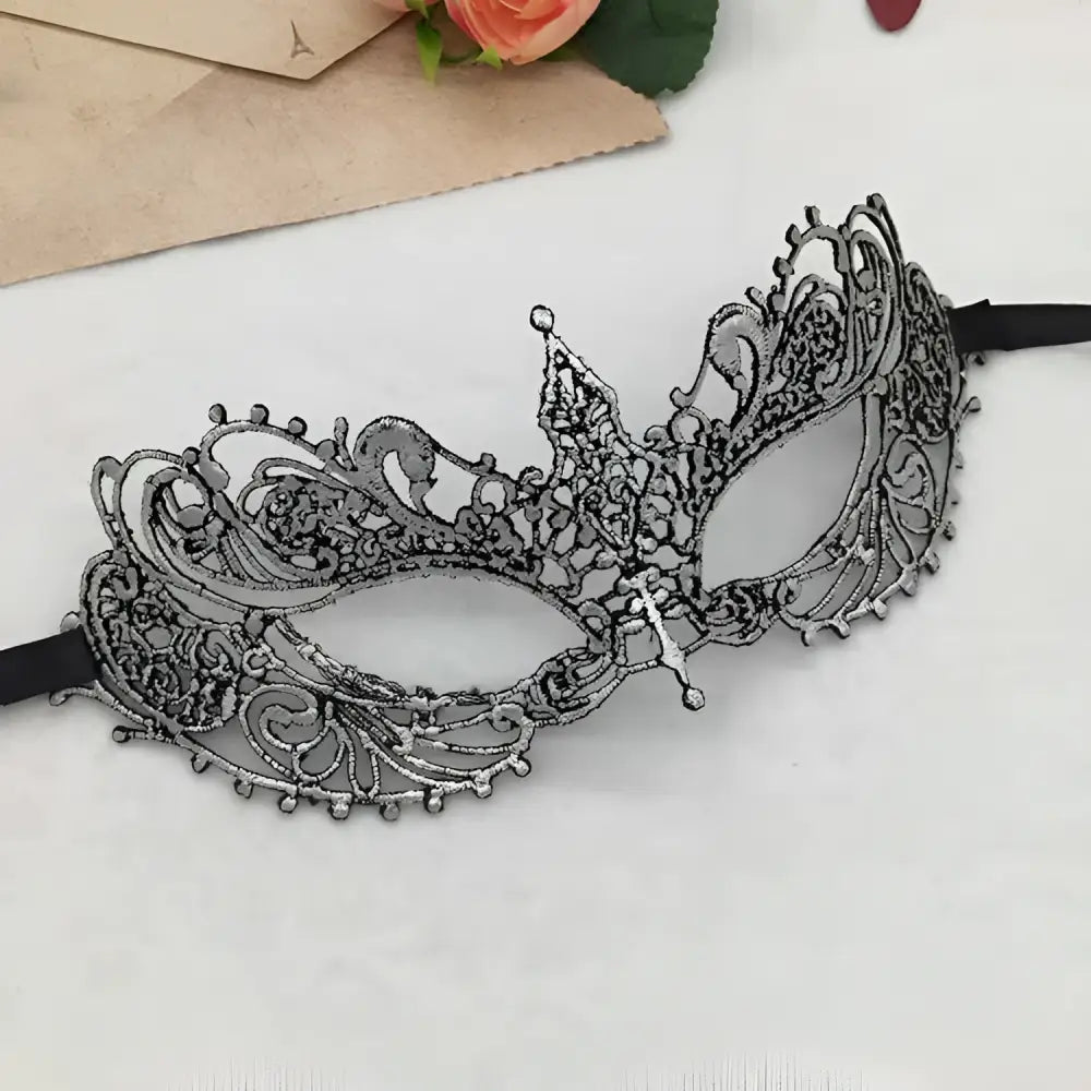 Elegant gold lace mask with intricate filigree design and black elastic straps for pointed halloween events