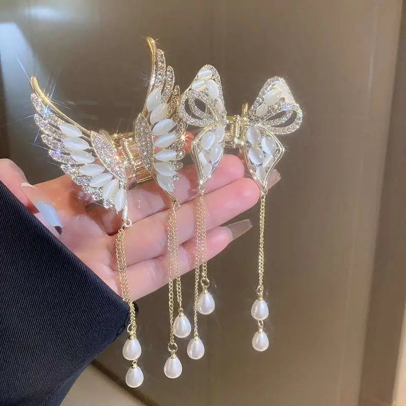 Elegant golden pearl tassel hairpin with gold-toned angel wing bow design featuring mother-of-pearl and dangling pearl drops