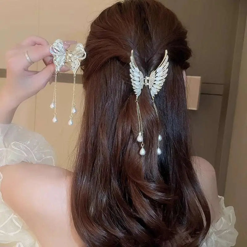 Elegant golden pearl tassel hairpin with silver wing-shaped design adorned with crystals and dangling pearl drops