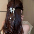 Elegant golden pearl tassel hairpin featuring a delicate silver butterfly with dangling pearl drops