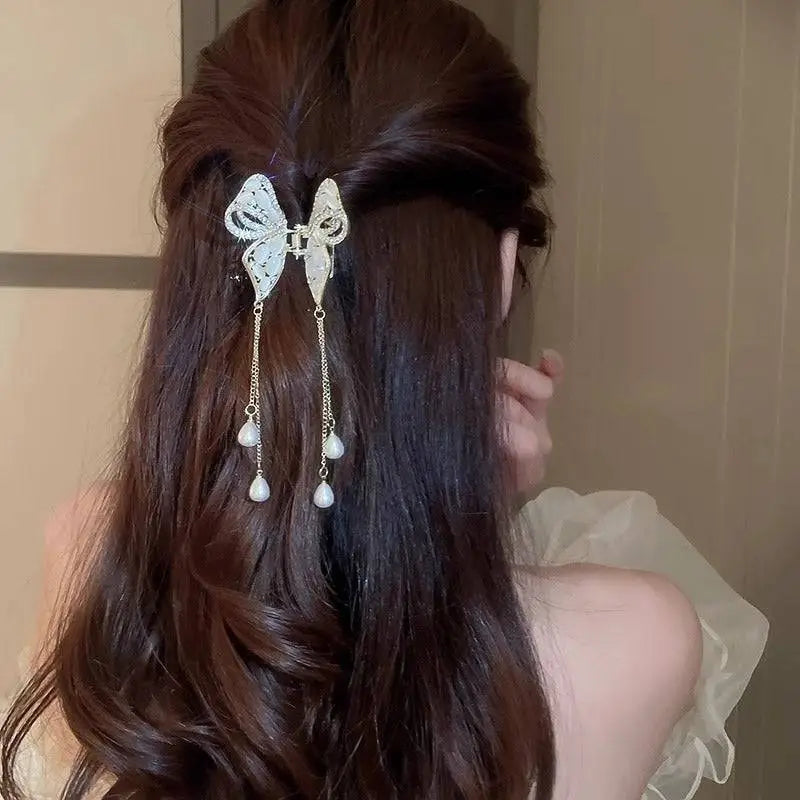 Elegant golden pearl tassel hairpin featuring a delicate silver butterfly with dangling pearl drops