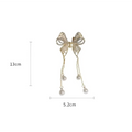 Elegant golden pearl tassel hairpin featuring a gold-toned butterfly with sparkling rhinestones and dangling pearl drops