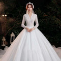 Elegant lace bridal gown in white featuring intricate lace detailing on the bodice and bridal temperament trailing sleeves