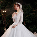 Elegant lace bridal gown in white with intricate lace detailing long sleeves and a voluminous skirt for bridal temperament trailing use