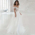 Elegant lace light wedding dress featuring a white off-the-shoulder wedding gown with intricate lace detailing and a flowing tulle skirt