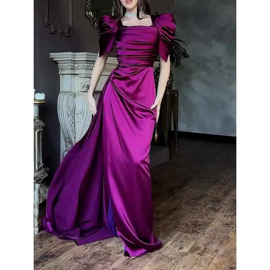 Elegant puff sleeve pleated slit magenta maxi dress made of shimmering satin with fitted waist and flowing train