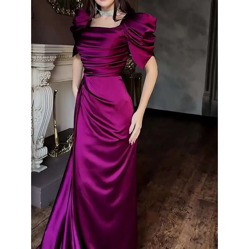 A shimmering magenta satin elegant puff sleeve pleated slit magenta maxi dress with puffed sleeves and a high slit