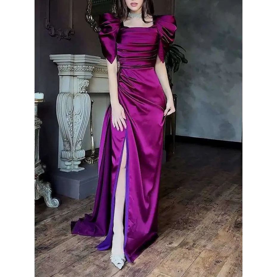 A shimmering magenta satin magenta maxi dress with elegant puff sleeve and pleated high slit design