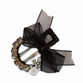 Elegant rhinestone mesh butterfly hairpin with black sheer bow, clear and gold-toned rhinestones, and white floral accent