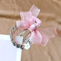 An elegant rhinestone mesh butterfly hairpin featuring a delicate pink organza bow and a white floral accent