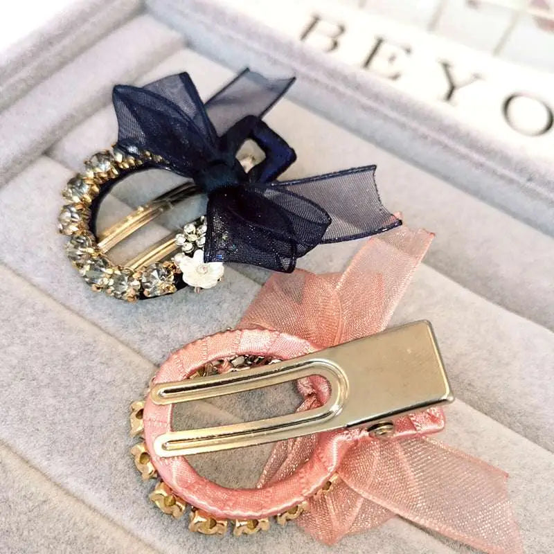 Elegant rhinestone mesh butterfly hairpin with sparkling rhinestones, sheer bows in black, pink, navy, and silver with floral accents